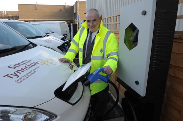 Cllr Ernest Gibson charging one of the electric vehicles in the Council's fleet