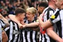 Lewis Miley (L) of Newcastle United celebrates with teammate Anthony Gordon after scoring their team's first goal during the Premier League match between Newcastle United and Fulham FC at St. James Park on December 16, 2023 in Newcastle upon Tyne, England. (Photo by Stu Forster/Getty Images)