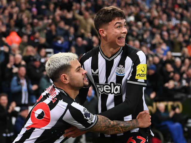 Lewis Miley of Newcastle United (R) celebrates with teammate Bruno Guimaraes after scoring their team's first goal during the Premier League match between Newcastle United and Fulham FC at St. James Park on December 16, 2023 in Newcastle upon Tyne, England. (Photo by Stu Forster/Getty Images)