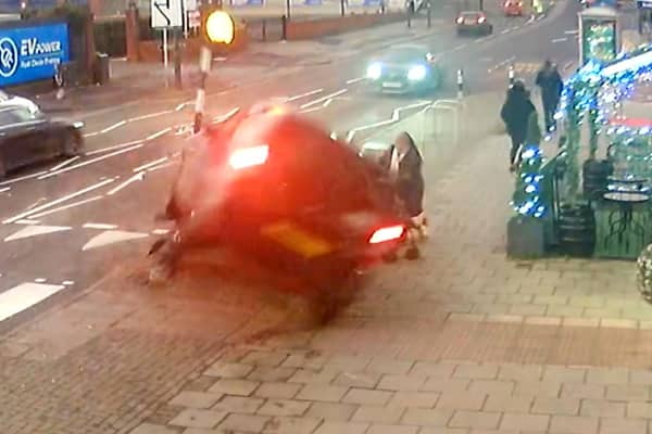 CCTV capturing the dramatic moment a mum managed to pull her two-year-old daughter to safety seconds before her pram was crushed underneath a car in a heart-stopping crash (SWNS)