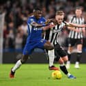 Moises Caicedo of Chelsea is challenged by Sean Longstaff of Newcastle United during the Carabao Cup Quarter Final match between Chelsea and Newcastle United at Stamford Bridge on December 19, 2023 in London, England. (Photo by Mike Hewitt/Getty Images)