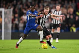 Moises Caicedo of Chelsea is challenged by Sean Longstaff of Newcastle United during the Carabao Cup Quarter Final match between Chelsea and Newcastle United at Stamford Bridge on December 19, 2023 in London, England. (Photo by Mike Hewitt/Getty Images)