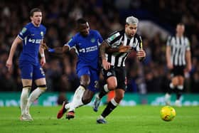 Chelsea's Ecuadorian midfielder #25 Moises Caicedo (L) fights for the ball with Newcastle United's Brazilian midfielder #39 Bruno Guimaraes during the English League Cup quarter-final football match between Chelsea and Newcastle United at Stamford Bridge in London on December 19, 2023. (Photo by Adrian DENNIS / AFP)