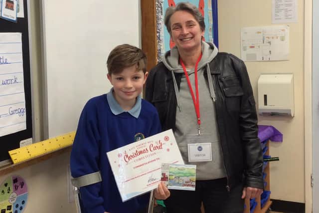 Jacob, pictured with his Christmas card, and with MP Kate Osborne.