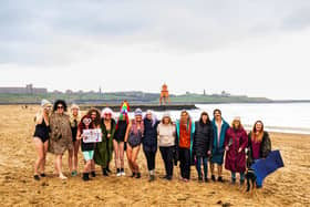 Victoria Thompson (middle with the purple hat) hopes to inspire others to take up cold water therapy as a way of improving their own mental health. Photo: Connor Rowden.