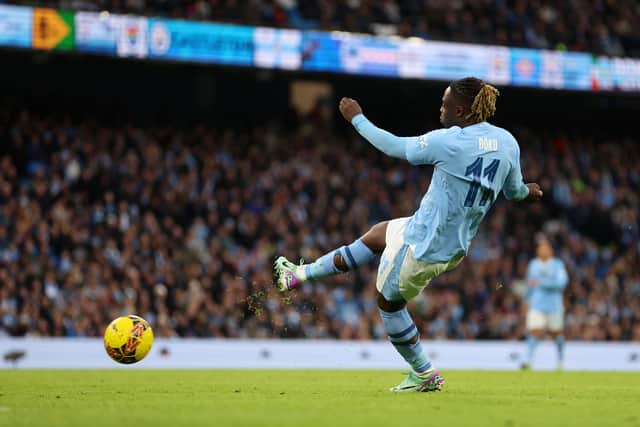 Jeremy Doku scores Manchester City's fifth goal against Huddersfield Town.