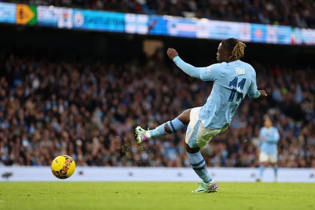 Jeremy Doku scores Manchester City's fifth goal against Huddersfield Town. 
