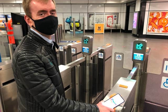 A passenger using the new Metro smartphone ticket app. 