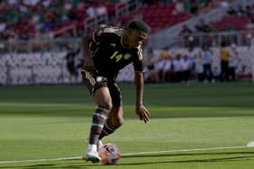  Dujuan Richards #14 of Jamaica dribbling the ball gains control against Saint Kitts and Nevis. (Photo by Thearon W. Henderson/Getty Images)