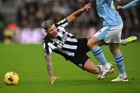 Newcastle United's Brazilian midfielder #39 Bruno Guimaraes takes a tumble during the English Premier League football match between Newcastle United and Manchester City at St James' Park in Newcastle-upon-Tyne, north east England on January 13, 2024. (Photo by Oli SCARFF / AFP) 