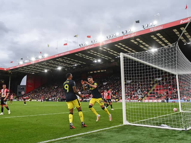 Miguel Almiron of Newcastle celebrates his goal with team mate Callum Wilson during the Premier League match between Sheffield United and Newcastle United at Bramall Lane on September 24, 2023 in Sheffield, England. (Photo by Michael Regan/Getty Images)