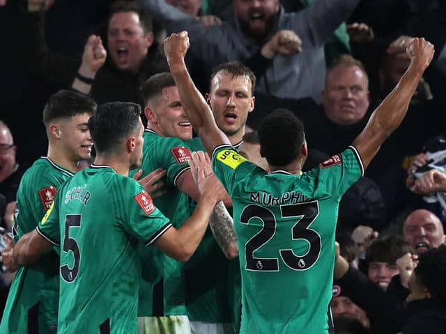 Newcastle United's English defender #33 Dan Burn (C) celebrates with teammates after scoring their second goal during the English FA Cup fourth round football match between Fulham and Newcastle United at Craven Cottage in London on January 27, 2024. (Photo by Adrian DENNIS / AFP)
