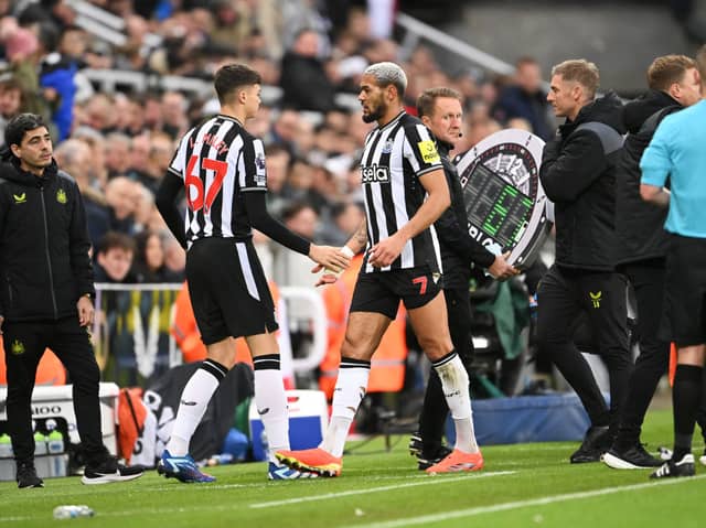 Joelinton of Newcastle United (R) reacts as he is substituted off injured for teammate Lewis Miley during the Premier League match between Newcastle United and Fulham FC at St. James Park on December 16, 2023 in Newcastle upon Tyne, England. (Photo by Stu Forster/Getty Images)