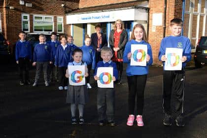 Cllr Jane Carter and headteacher Donna Scott are pictured with some of the pupils celebrating the 'Good' result.