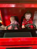 Elijah and Layla driving the fire engine 
