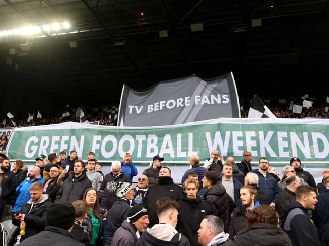 Fans of Newcastle United hold up banners reading 'Tv Before Fans' and 'Green Football Weekend' during the Premier League match between Newcastle United and Luton Town at St. James Park on February 03, 2024 in Newcastle upon Tyne, England. (Photo by Matt McNulty/Getty Images)