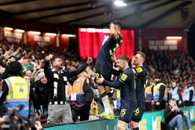 Bruno Guimaraes of Newcastle United celebrates scoring his team's third goal with teammates and fans during the Premier League match between Nottingham Forest and Newcastle United at City Ground on February 10, 2024 in Nottingham, England. (Photo by Catherine Ivill/Getty Images)