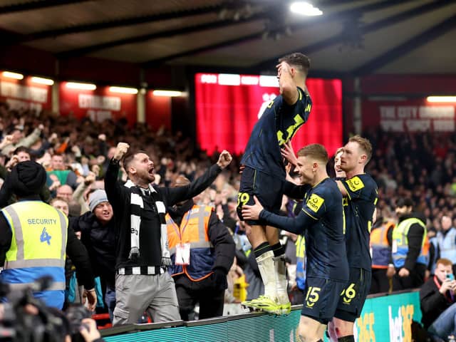 Bruno Guimaraes of Newcastle United celebrates scoring his team's third goal with teammates and fans during the Premier League match between Nottingham Forest and Newcastle United at City Ground on February 10, 2024 in Nottingham, England. (Photo by Catherine Ivill/Getty Images)