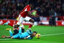 Taiwo Awoniyi of Nottingham Forest clashes with Martin Dubravka of Newcastle United  during the Premier League match between Nottingham Forest and Newcastle United at City Ground on February 10, 2024 in Nottingham, England. (Photo by Mark Thompson/Getty Images)