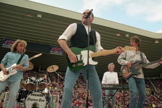 Status Quo performing at the Stadium of Light in July 1997.