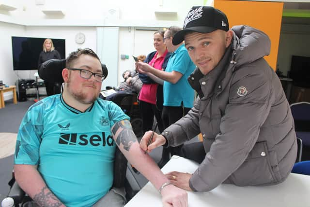 Kieran Trippier signing Ewan's arm