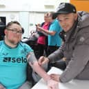 Kieran Trippier signing Ewan's arm