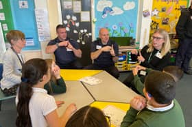 TWFRS Watch Manager Steven Walker and firefighter Paul O'Neil are shown ‘simple signs’ by young people and staff from Broadwood Primary School HIARP and Jesmond Park Academy HIARP.