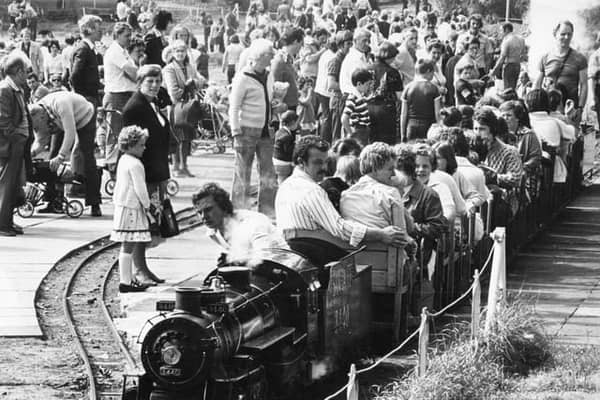 Back to 1980 and August Bank Holiday crowds at the South Marine Park, watch as a hard worked steam engine takes another load of passengers for a trip around the lake.
