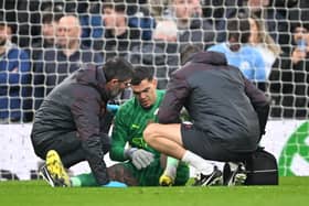 Ederson of Manchester City receives medical treatment after sustaining an injury and is later substituted off during the Premier League match between Liverpool FC and Manchester City at Anfield on March 10, 2024 in Liverpool, England. (Photo by Michael Regan/Getty Images)
