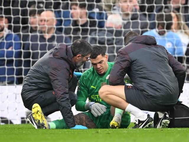 Ederson of Manchester City receives medical treatment after sustaining an injury and is later substituted off during the Premier League match between Liverpool FC and Manchester City at Anfield on March 10, 2024 in Liverpool, England. (Photo by Michael Regan/Getty Images)