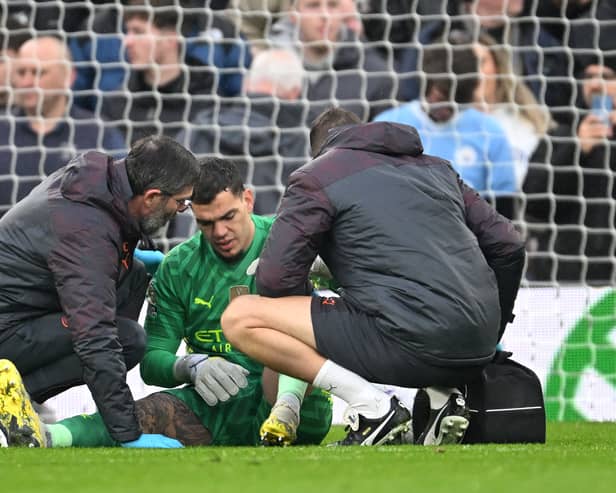 Ederson of Manchester City receives medical treatment after sustaining an injury and is later substituted off during the Premier League match between Liverpool FC and Manchester City at Anfield on March 10, 2024 in Liverpool, England. (Photo by Michael Regan/Getty Images)