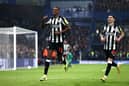 Alexander Isak of Newcastle United celebrates scoring his team's first goal with teammate Miguel Almiron during the Premier League match between Chelsea FC and Newcastle United at Stamford Bridge on March 11, 2024 in London, England. (Photo by Alex Pantling/Getty Images)