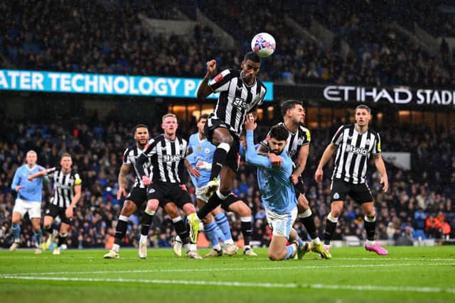 Alexander Isak heads the ball for Newcastle United against Manchester City. 