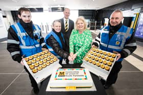 Huw Lewis, Nexus Customer Services Director (centre back) and members of Metro's customer service teams cutting the commemorative cake with Cllr Audrey Huntley, Deputy Leader of South Tyneside Council. Photo: Nexus.