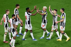 Bruno Guimaraes and Alexander Isak celebrate in the Champions League. 