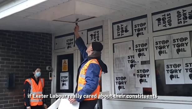 Just Stop Oil protesters fly-post Exeter Labour HQ. The protesters stuck posters and print outs of a letter they had sent to parliamentary candidate Steve Race to the building.