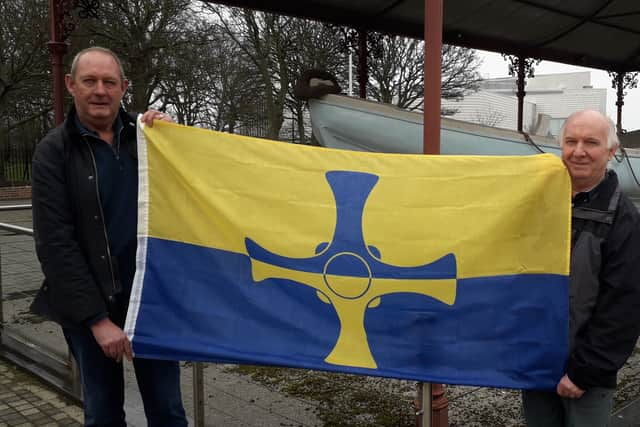 South Shields residents Graeme Keedy (L) and Terry Ford (R) with the County Durham flag at the restored "Tyne" lifeboat. 