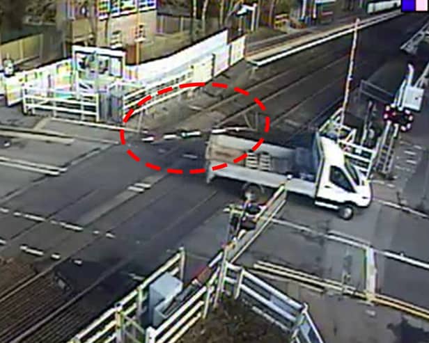 The van smashed through the level crossing barrier and dragged it along.