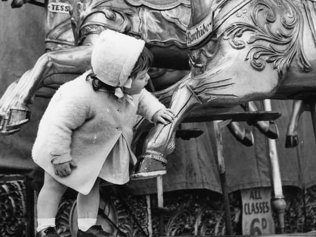 Back to 1964 and 18 month old Shirley Hughes seems fascinated by the rides at the amusement park.