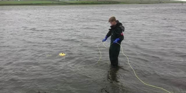 The team search a lake for Excalibur.