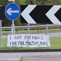 Protest sign at a roundabout on Eastern Way in Daventry - A series of protest signs highlighting the Daventry pothole problem by the mystery campaigner.  