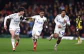 Crysencio Summerville of Leeds United celebrates scoring alongside Archie Gray and Georginio Rutter 