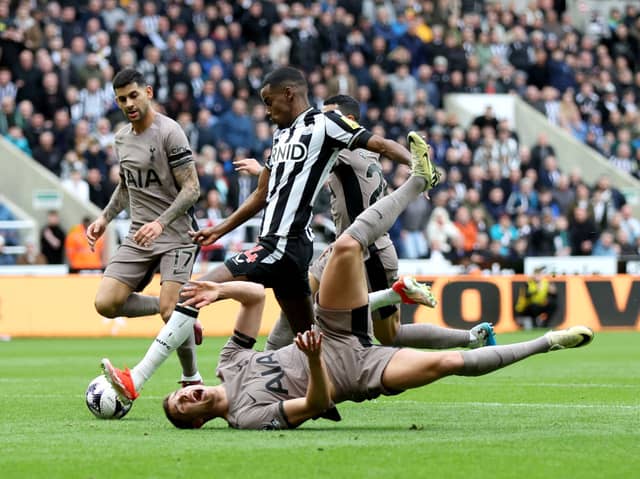 Alexander Isak of Newcastle United scores his team's first goal as Micky van de Ven of Tottenham Hotspur goes down during the Premier League match between Newcastle United and Tottenham Hotspur at St. James Park on April 13, 2024 in Newcastle upon Tyne, England. (Photo by George Wood/Getty Images) (Photo by George Wood/Getty Images)