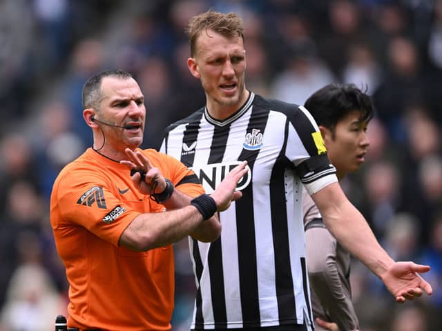 Newcastle United player Dan Burn reacts as referee Tim Robinson makes a point during the Premier League match between Newcastle United and Tottenham Hotspur at St. James Park on April 13, 2024 in Newcastle upon Tyne, England. (Photo by Stu Forster/Getty Images) (Photo by Stu Forster/Getty Images)
