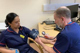Darshini Smith and Ian Storer, Heart Failure Specialist Nurses with STSFT, show how a patient's blood pressure is checked.
