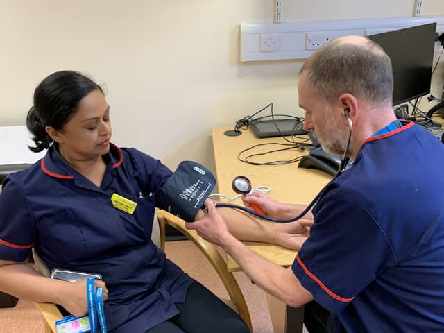 Darshini Smith and Ian Storer, Heart Failure Specialist Nurses with STSFT, show how a patient's blood pressure is checked.