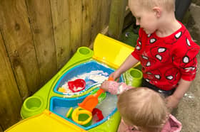 Elijah and Layla enjoying the sand and water table