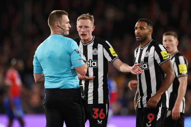 Sean Longstaff and Callum Wilson of Newcastle United interact with referee Tom Bramall during the Premier League match between Crystal Palace and Newcastle United at Selhurst Park on April 24, 2024 in London, England. (Photo by Ryan Pierse/Getty Images)