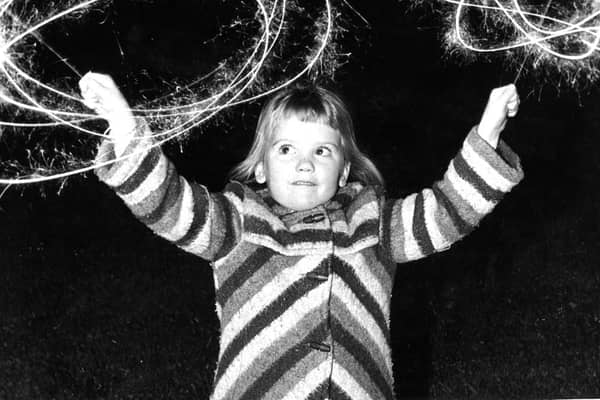 Emma Louise Lynn enjoys her sparklers at the Bents Park fireworks display in 1981.