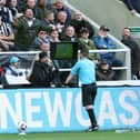 Tony Harrington checks the Video Assistant Referee screen during the Premier League match between Newcastle United and Sheffield United at St. James Park